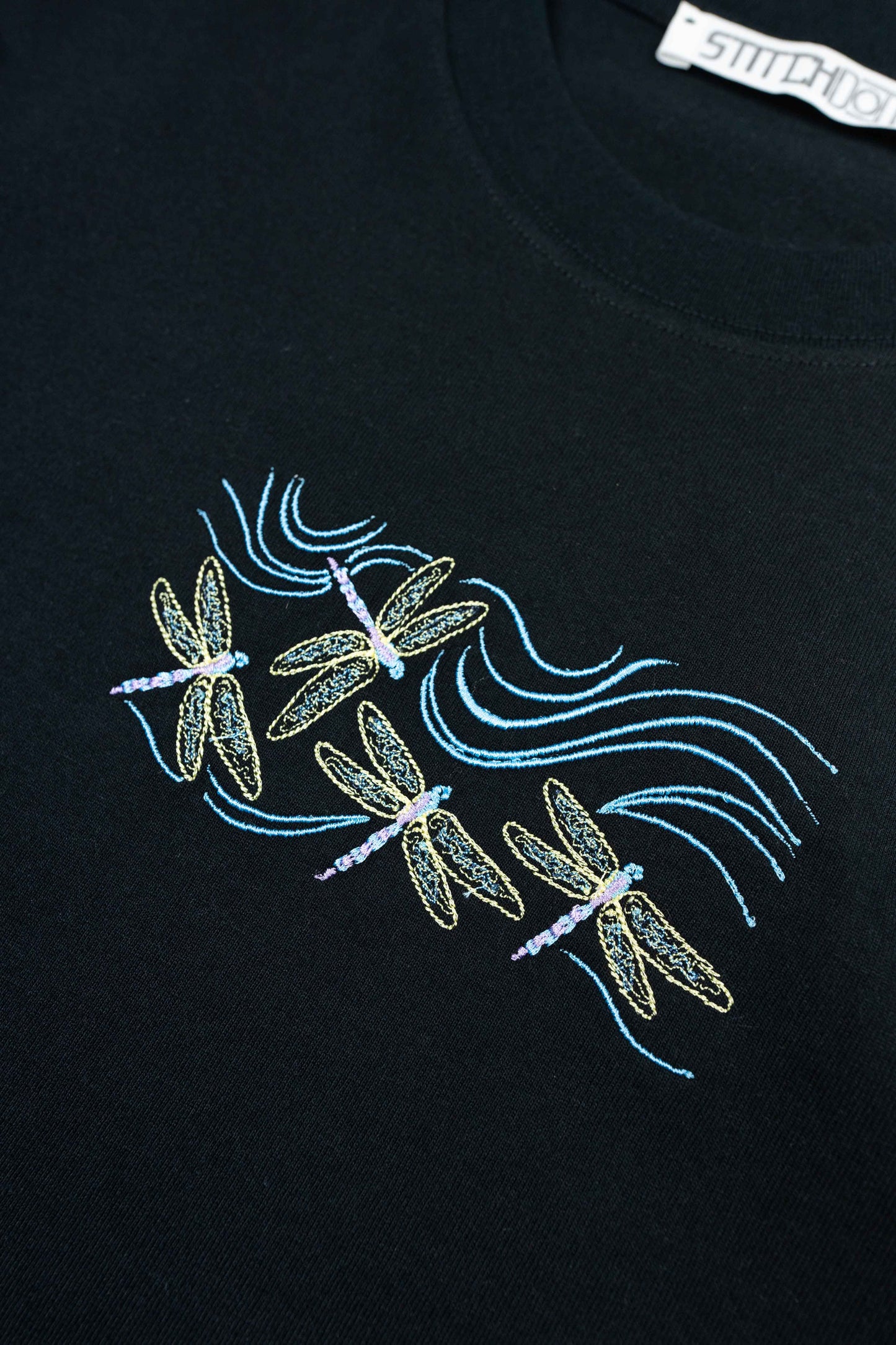Luxury organic cotton women’s T-shirt with dragonfly design.