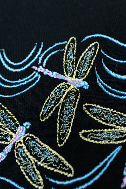 Sustainable organic T-shirt for women featuring a dragonfly embroidery.