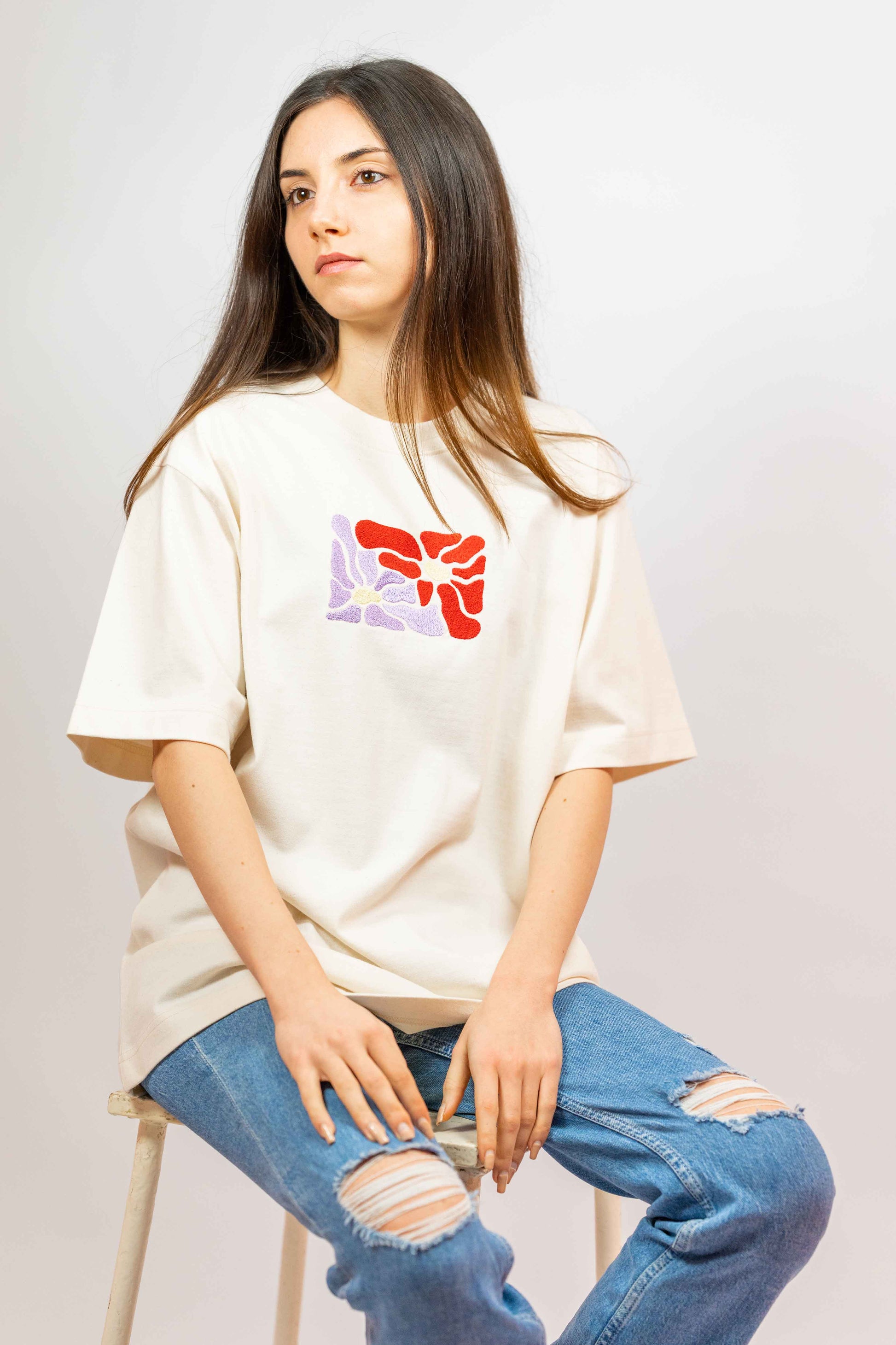 Sustainable women’s t-shirt featuring intricate floral embroidery in an oversized design.