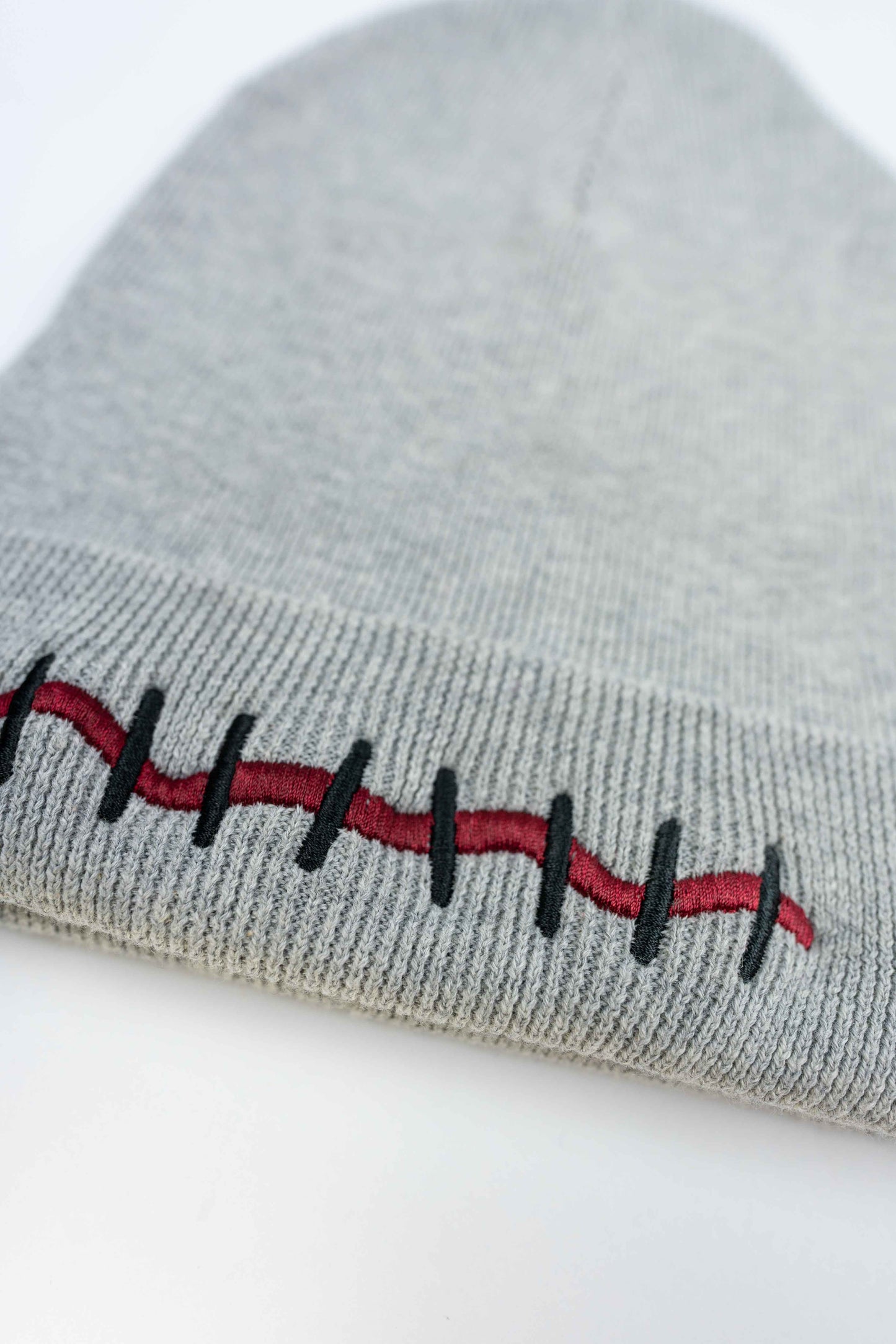 Luxury gray organic cotton beanie with intricate Mouth Scar design.