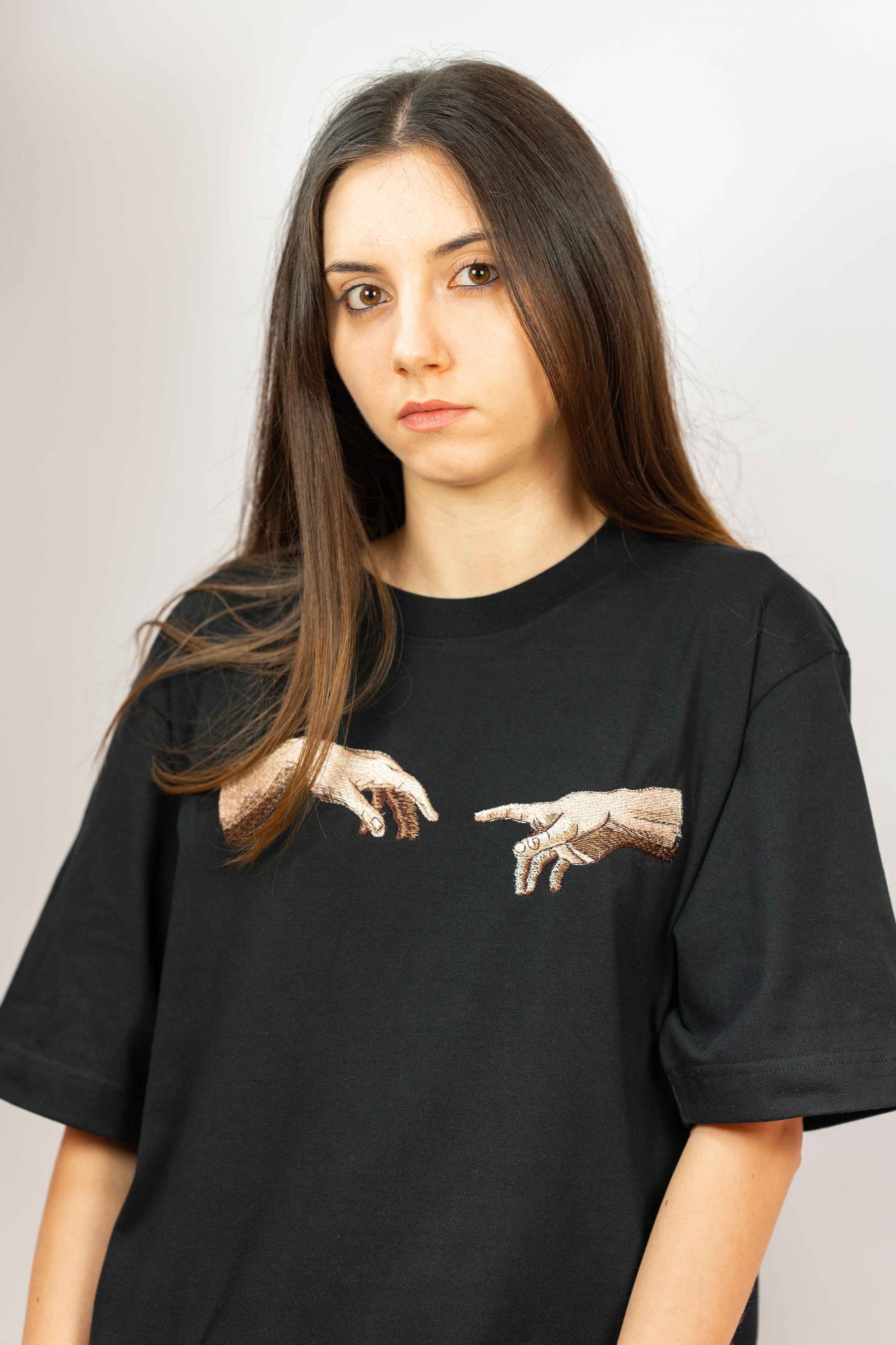 Premium organic cotton t-shirt featuring The Creation of Adam embroidery.