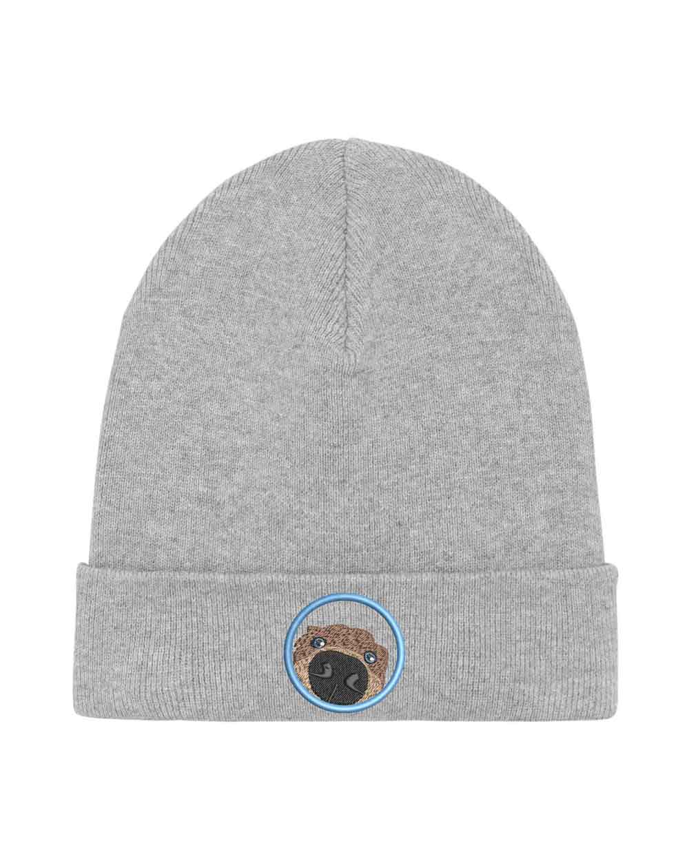 Căciulă gri din tricot cu manșetă întoarsă, brodată cu un patch circular cu față de pug, un accesoriu simpatic și jucăuș pentru iubitorii de câini.