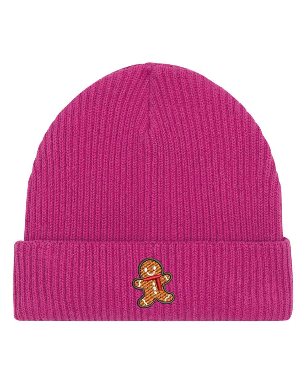 Căciulă roz din tricot cu manșetă întoarsă, brodată cu un omuleț de turtă dulce pe partea frontală, un accesoriu drăguț și festiv pentru sezonul rece.