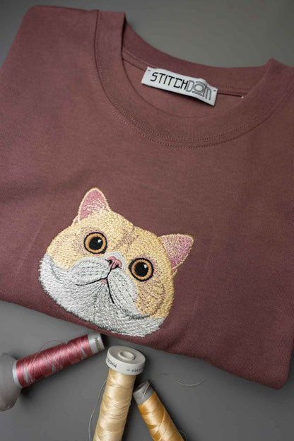 Tricou maro cu model brodat reprezentând fața unei pisici bej.
