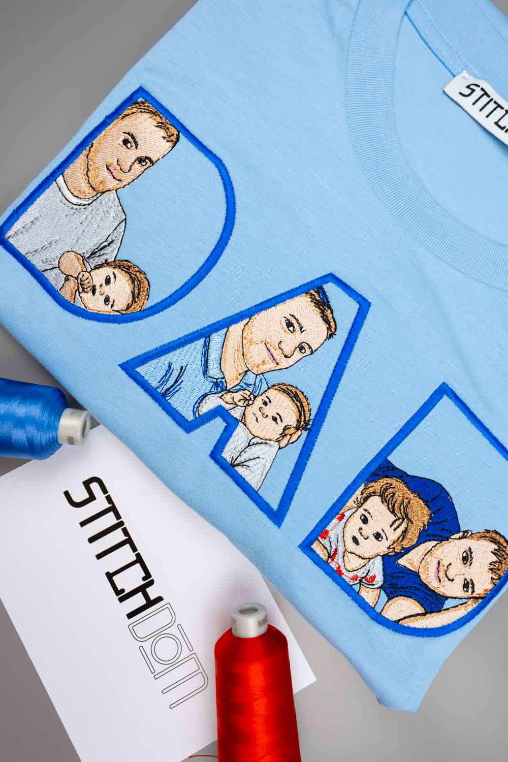 Tricou bleu deschis din bumbac organic, cu literele mari „D” și „A” brodate personalizat, având în interior portrete ilustrate brodate cu un tată și copilul său, aranjat flat lay, alături de conuri de ață bleu și roșie și o etichetă de brand „StitchDOM”.