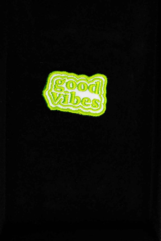 Patch brodat negru cu mesajul „Good Vibes” în verde, un accesoriu cu energie pozitivă pentru haine și genți.