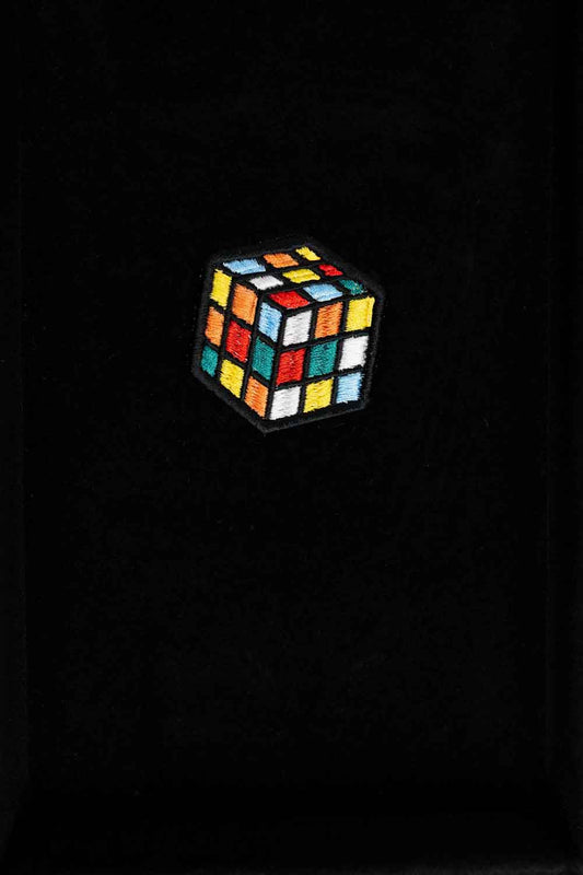 Patch brodat cu design de cub Rubik colorat pe fundal negru, un accesoriu inspirat de jocurile clasice.