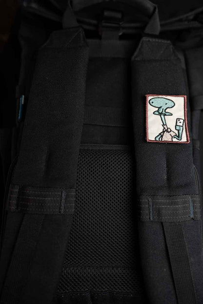 Patch brodat cu design amuzant inspirat de Patrick din SpongeBob, ținând o cameră foto pentru selfie, în culori roz și alb, un accesoriu creativ pentru personalizare.