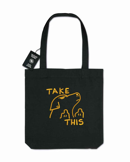 Tote bag brodat negru cu text galben „Take This” și ilustrație de câine, un design amuzant purtat în aer liber.